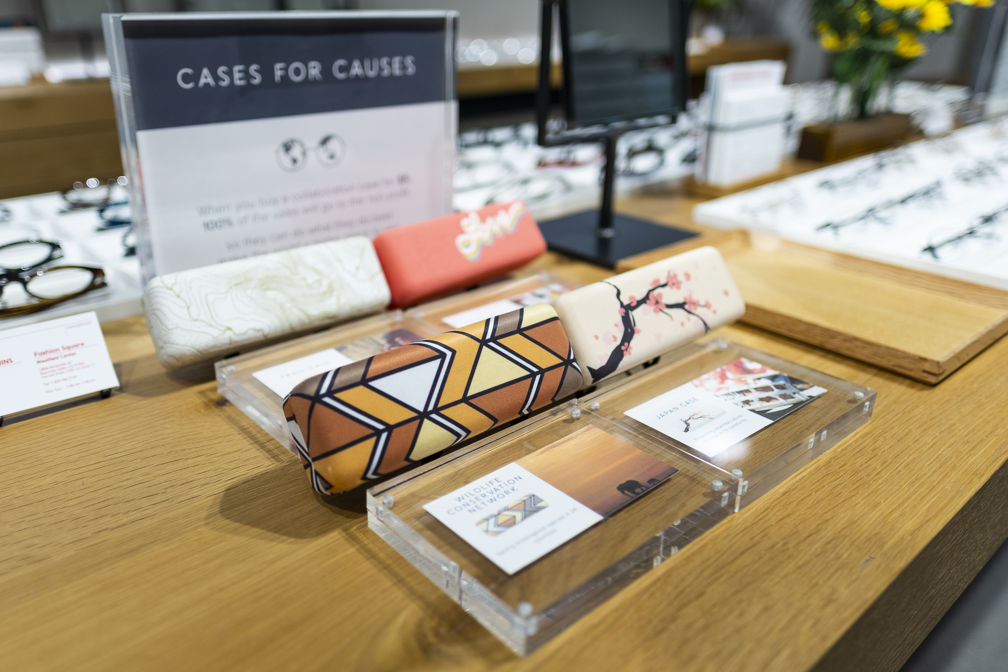 Cases for Causes display fixture at JINS Stores